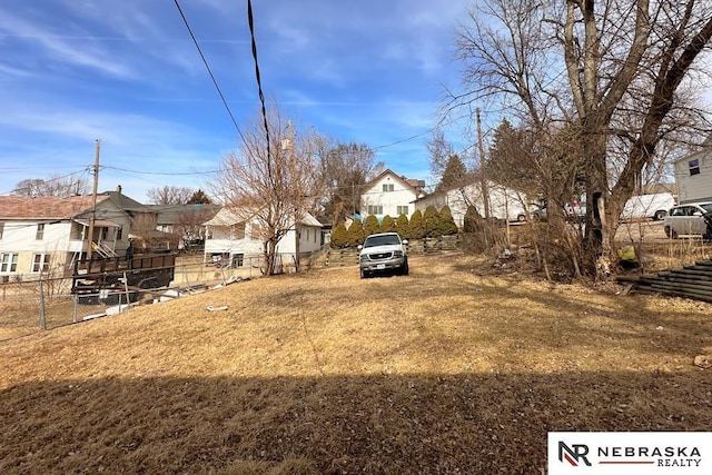 view of yard featuring a residential view and fence