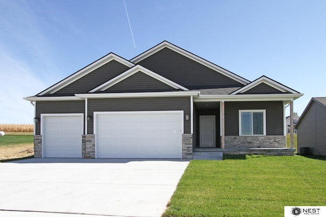 craftsman-style home featuring stone siding, driveway, a front lawn, and an attached garage