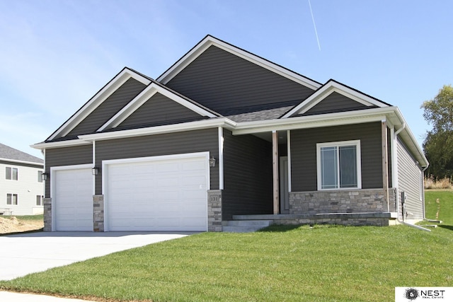 craftsman inspired home with stone siding, driveway, a front yard, and a garage