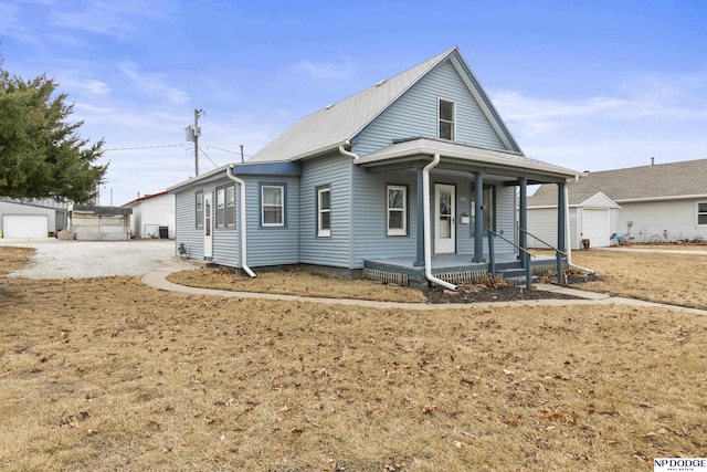 bungalow featuring an outbuilding and covered porch