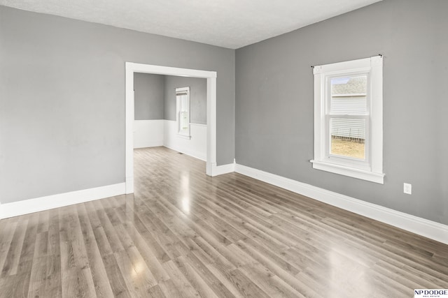 unfurnished room featuring baseboards and wood finished floors