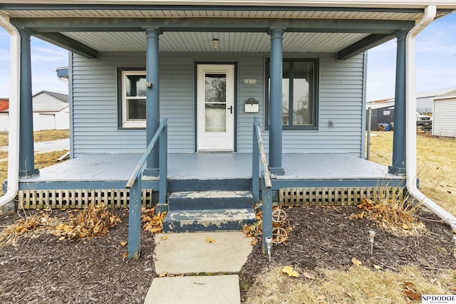 view of exterior entry with a porch