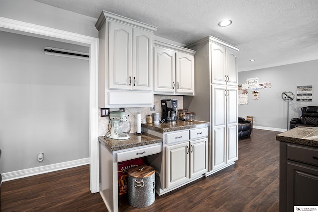 kitchen with tile counters, dark wood-style floors, baseboards, and backsplash