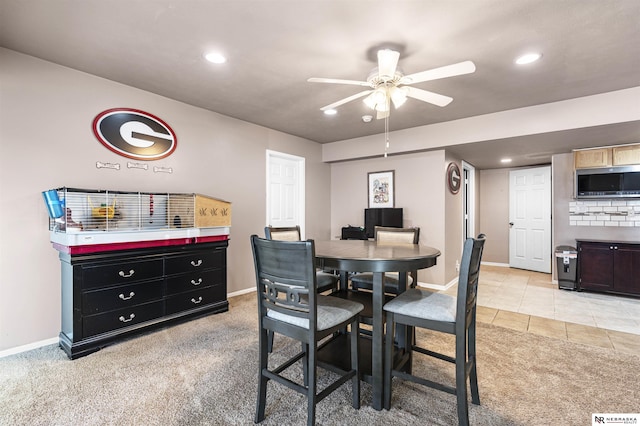 dining area with a ceiling fan, recessed lighting, light colored carpet, and baseboards