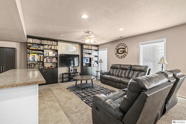 living area featuring ceiling fan, light tile patterned floors, recessed lighting, and a textured ceiling