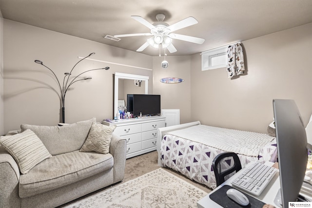 bedroom featuring visible vents, light colored carpet, and a ceiling fan