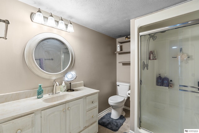 bathroom with toilet, a stall shower, a textured ceiling, baseboards, and vanity