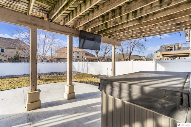 view of patio with a fenced backyard and a hot tub