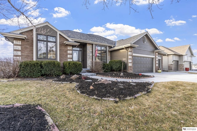 ranch-style house featuring a shingled roof, concrete driveway, an attached garage, a front yard, and brick siding