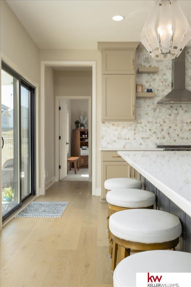 kitchen with open shelves, stovetop, light wood-style flooring, light countertops, and tasteful backsplash