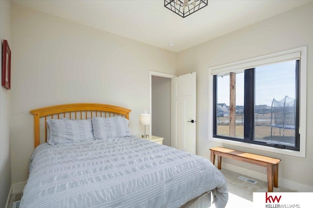 bedroom with visible vents and baseboards