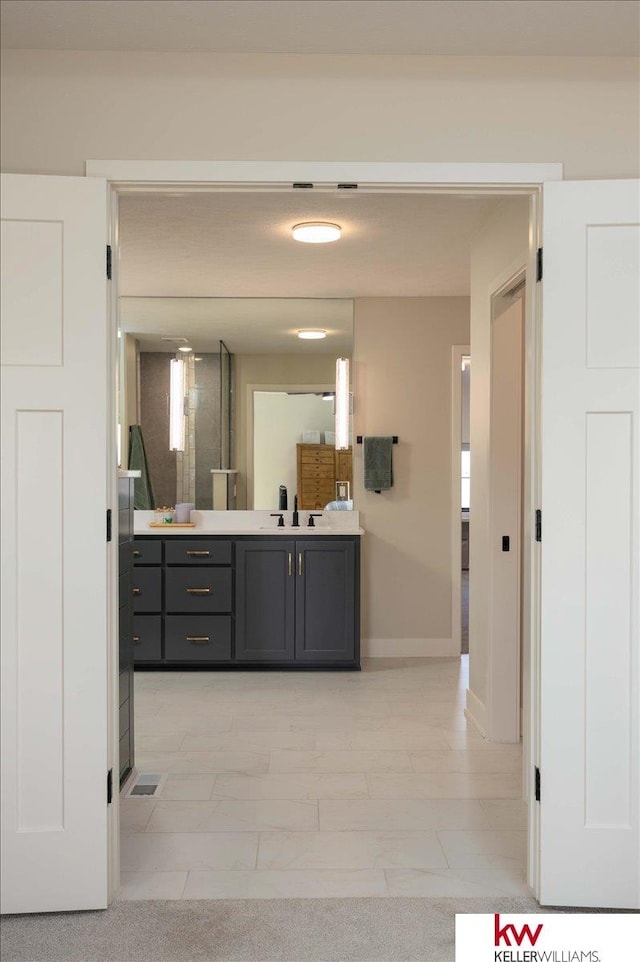 bathroom featuring vanity and baseboards