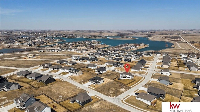 drone / aerial view featuring a water view and a residential view