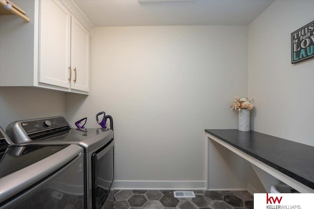 clothes washing area featuring visible vents, cabinet space, independent washer and dryer, and baseboards