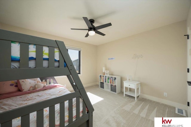 bedroom featuring a ceiling fan, baseboards, visible vents, and light carpet