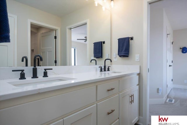 full bathroom featuring double vanity, visible vents, baseboards, and a sink