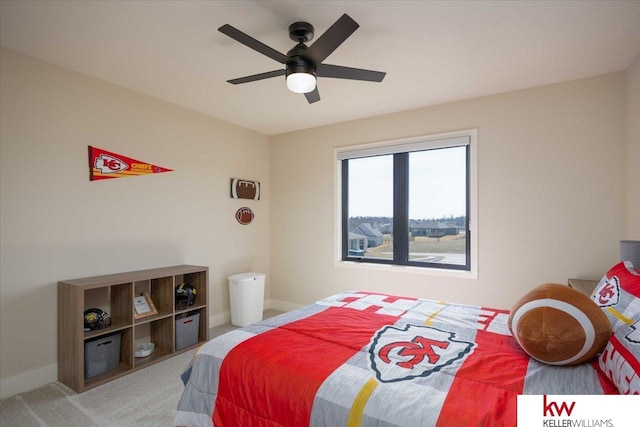 carpeted bedroom with a ceiling fan and baseboards