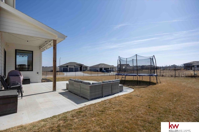 view of patio / terrace featuring an outdoor living space, a trampoline, and fence