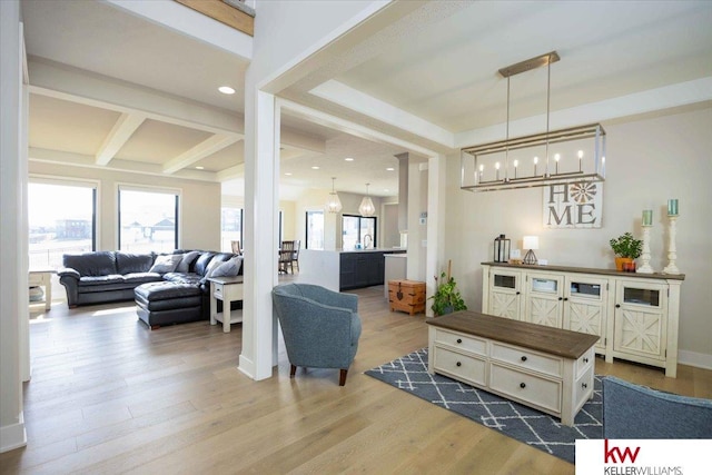 living area featuring beam ceiling, recessed lighting, wood finished floors, and baseboards