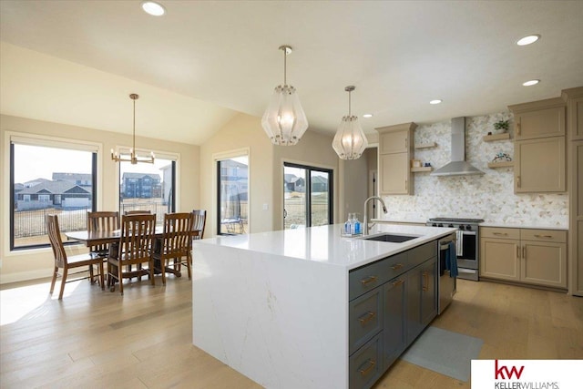 kitchen with a sink, wall chimney range hood, a chandelier, stainless steel stove, and open shelves