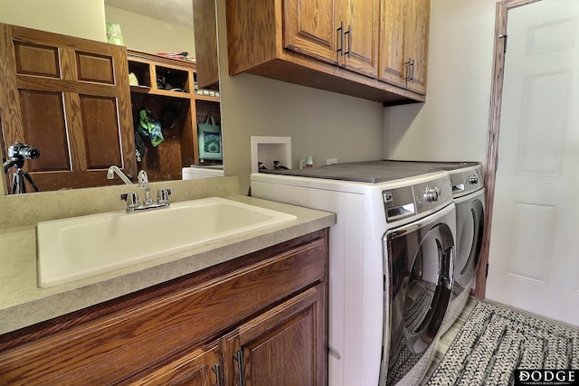 laundry area featuring a sink, cabinet space, light tile patterned floors, and washer and clothes dryer