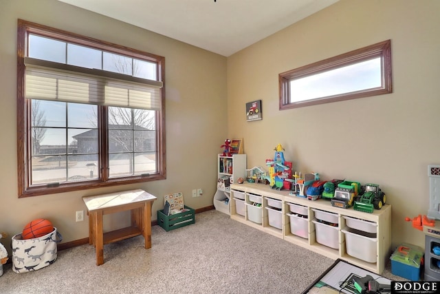 playroom featuring baseboards and light colored carpet