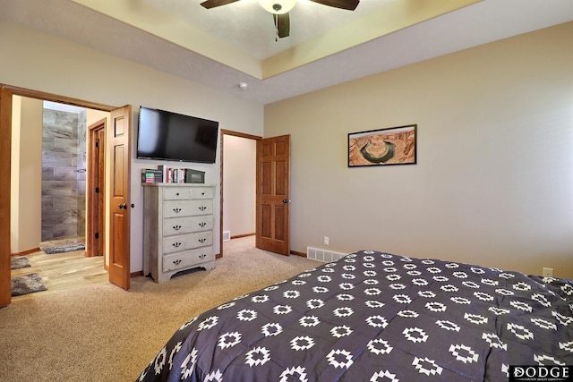 bedroom with a ceiling fan, carpet, visible vents, baseboards, and a raised ceiling