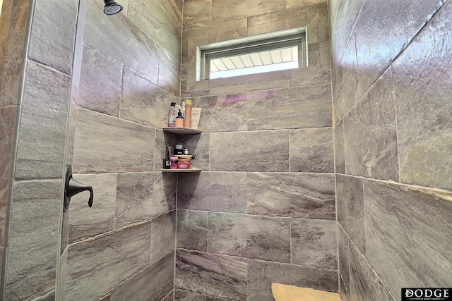 full bath featuring tiled shower