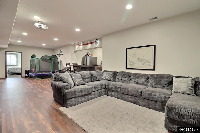 living area featuring dark wood-style floors, visible vents, and recessed lighting