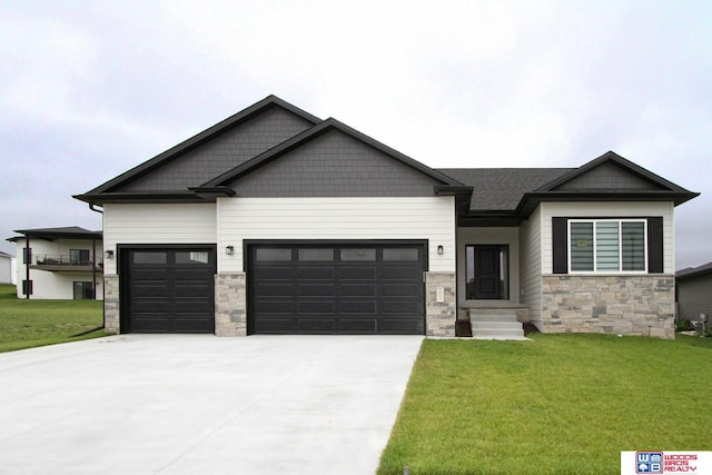 craftsman-style house featuring a garage, stone siding, concrete driveway, and a front yard