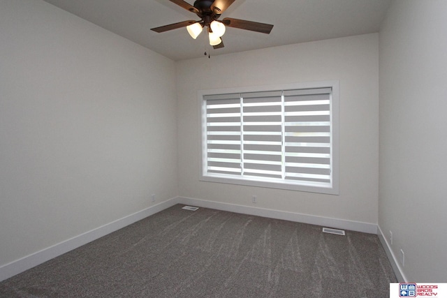 unfurnished room featuring visible vents, baseboards, dark colored carpet, and ceiling fan