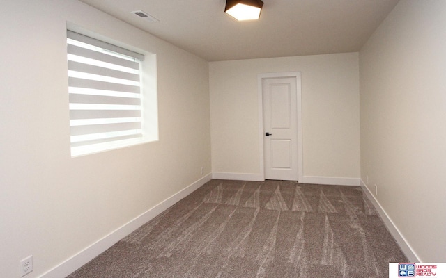 spare room featuring visible vents, baseboards, and carpet floors