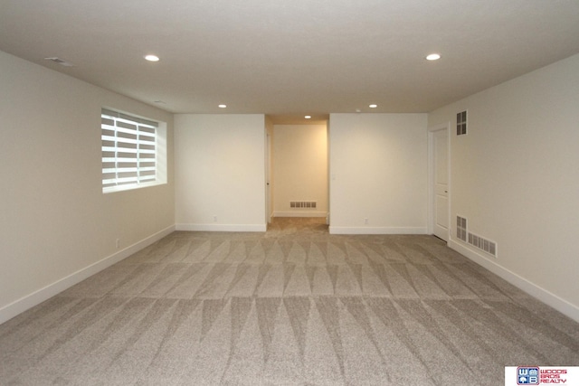 unfurnished room with light carpet, visible vents, and recessed lighting