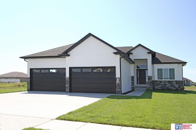 view of front of property featuring driveway, an attached garage, a shingled roof, a front lawn, and stone siding