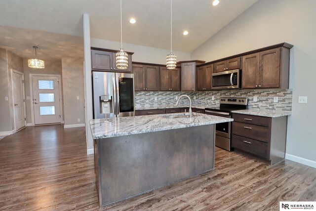 kitchen featuring a sink, dark brown cabinetry, appliances with stainless steel finishes, and dark wood-style flooring