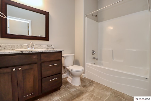 bathroom featuring toilet, vanity, and shower / tub combination