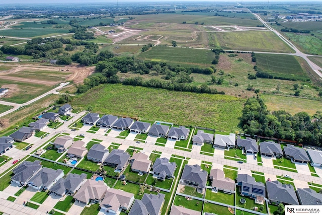 birds eye view of property with a rural view and a residential view