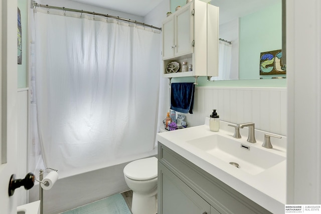 bathroom with vanity, shower / bath combination with curtain, and toilet