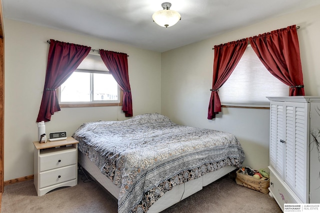 carpeted bedroom featuring baseboards