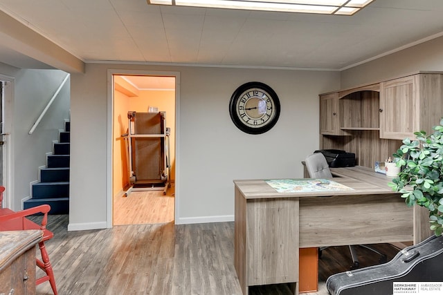 office featuring crown molding, baseboards, and wood finished floors