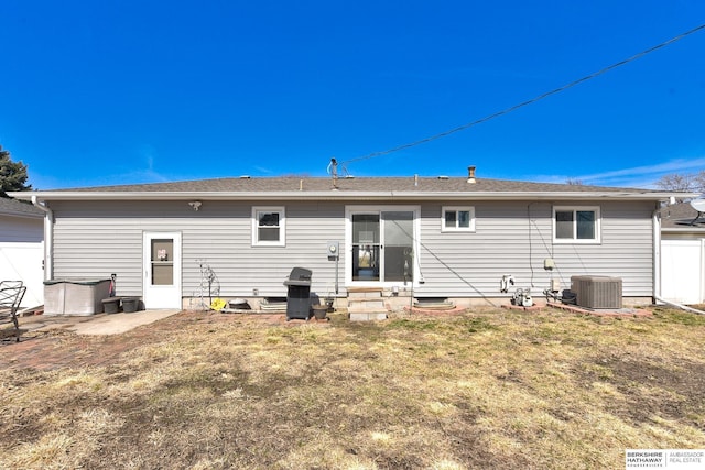 rear view of house featuring a lawn, central AC, and entry steps