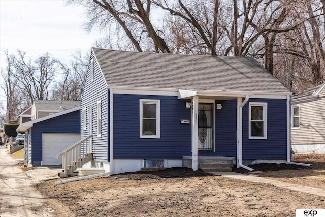 view of front of house with driveway and roof with shingles