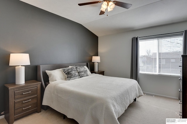 bedroom featuring visible vents, light carpet, lofted ceiling, baseboards, and ceiling fan