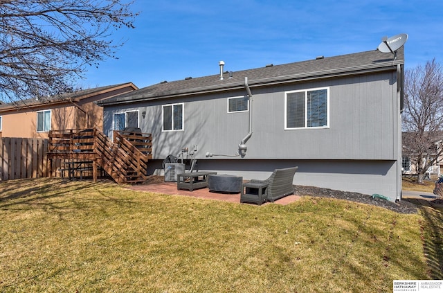 back of house featuring a patio, roof with shingles, a yard, and fence