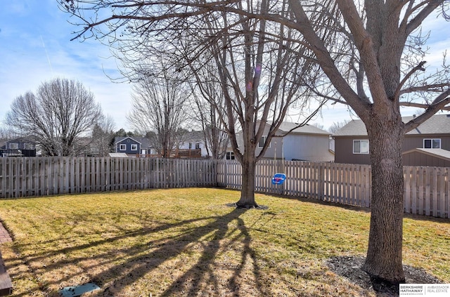 view of yard featuring a residential view and a fenced backyard