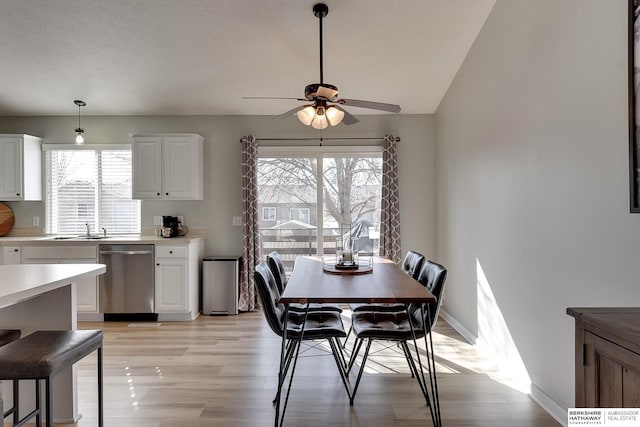 dining room with lofted ceiling, light wood-style floors, baseboards, and ceiling fan