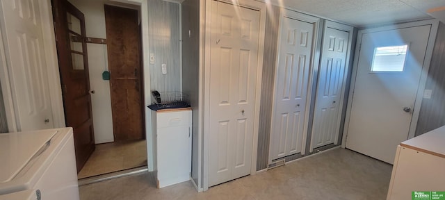 corridor with washing machine and clothes dryer