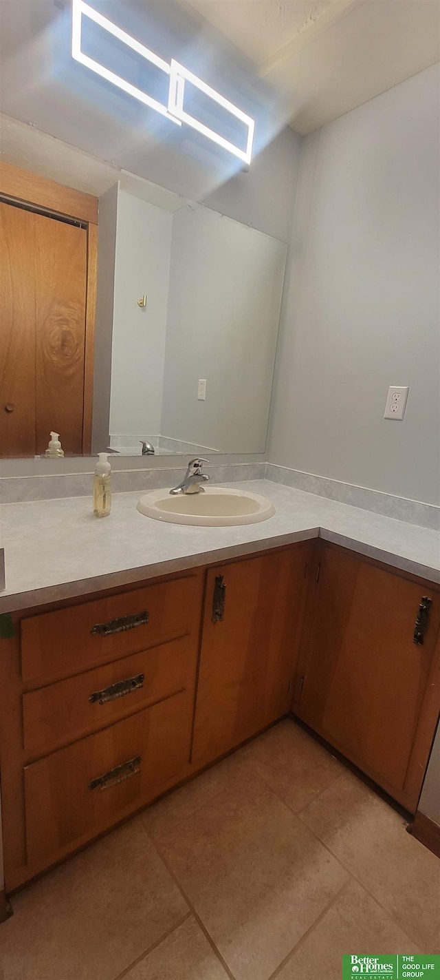 bathroom with tile patterned floors and vanity