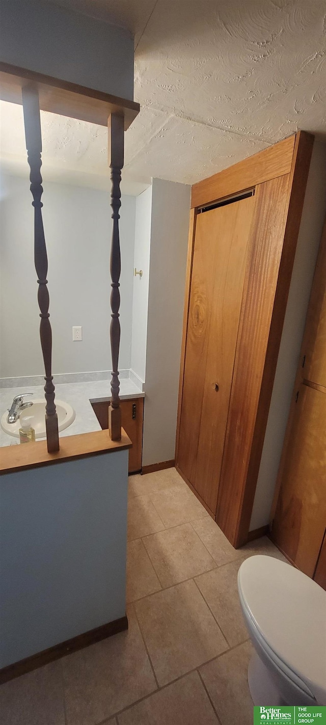 bathroom with tile patterned floors, toilet, and vanity