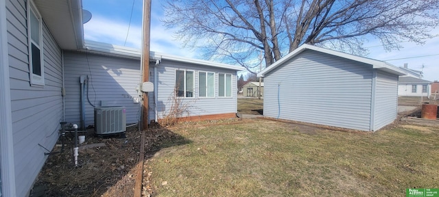 view of property exterior featuring a lawn and central AC unit